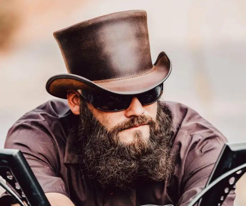 The Marlow Mens Leather Top Hat is handmade in the USA from 100% authentic top-grain cowhide leather. Loved by Harley Davidson, motorcycle and steampunk subculture enthusiasts, this short crown, coachman style men’s biker top hat is for the man who isn’t afraid to stand out in a crowd. It's available for purchase at our retail shop in Smyrna, TN, just outside of Nashville. We sale these unbanded so you can have a choice of a band or no band.