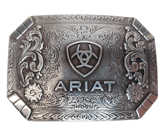 This rectangular buckle features rounded edges and a centered Ariat logo. The surface also boasts charming Western scroll and floral designs. The antique silver finish adds a touch of nostalgia. With a height of 2 1/2" and width of 3 1/2", it accommodates belts up to 2" wide. Purchase it on our online store or at our retail shop in Smyrna, TN, near Nashville. Imported