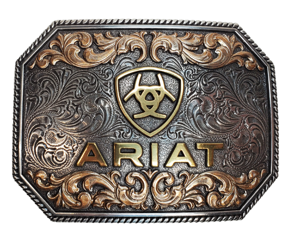 This rectangular shaped buckle has rounded edges and Ariat logo centered on surface. Surface also has scroll and flower designs and rope design around the border of the buckle. Color is antique chrome. Measures 2 1/2" tall by 3 1/2" wide.; Fits belts up to 2" wide. Available for purchase in our online store or the retail shop in Smyrna, TN, just outside Nashville. Imported