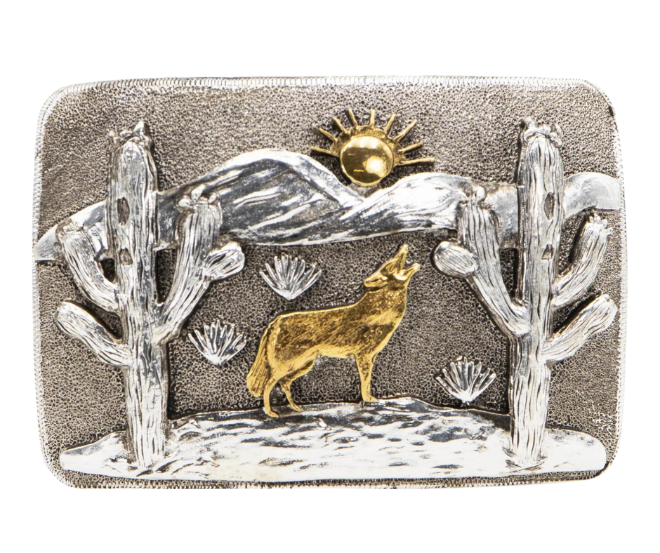 The Desert Coyote Belt Buckle features an intricate design of a howling coyote against a backdrop of mountains and cacti. With its antique gold and silver finish, this affordable option is a stylish addition to any wardrobe. Measuring 2 3/4" in height and 4" in width, the rectangular shape ensures a comfortable fit on belts up to 1 3/4" wide. You can easily purchase this buckle online or at our shop in Smyrna, TN, located just outside of Nashville.