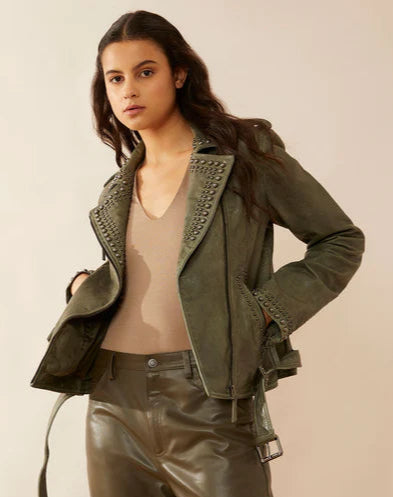 This stylish Olive green leather jacket features a MC style with a soft, supple feel. It boasts an off-center front zipper, a waist belt with a buckle, and various sizes of antiqued brass brads adorning the lapel, zippered front pockets, and the sleeve ends. You can now find it stocked at our Smyrna, TN store, just a short drive away from the famous downtown Nashville. Imported