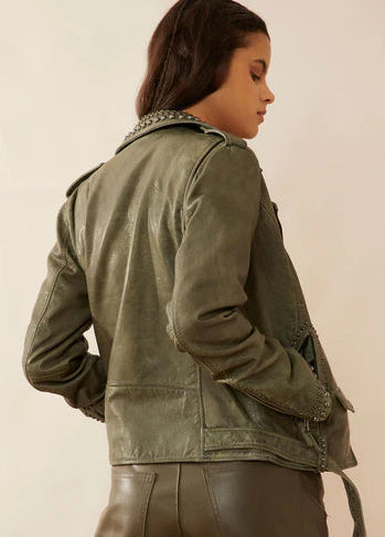 This stylish Olive green leather jacket features a MC style with a soft, supple feel. It boasts an off-center front zipper, a waist belt with a buckle, and various sizes of antiqued brass brads adorning the lapel, zippered front pockets, and the sleeve ends. You can now find it stocked at our Smyrna, TN store, just a short drive away from the famous downtown Nashville. Imported