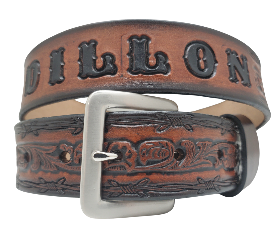 The "Bandit" Name Belt is perfect for those seeking an epic escape. It's handcrafted in Smyrna, Tennessee, just outside Nashville, and features a 1 1/2" width with a strip of vegetable tanned leather. The bold design includes an embossed Barbwire border and Western Scroll center pattern, while the changeable solid brass buckle in antique nickel finish adds a rugged touch. Make your escape in style with this hand-stained belt.