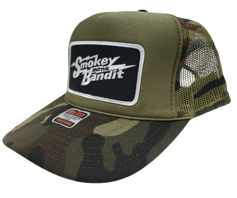 Take risks and show your adventurous spirit with our black and green camo mesh vintage foam trucker Smoky and the Bandit cap! The iconic Bandit logo meets the USA flag in this unique design. Get yours now at our Smyrna, TN store or online for the ultimate challenge and inspiration! Snap back adjustment.