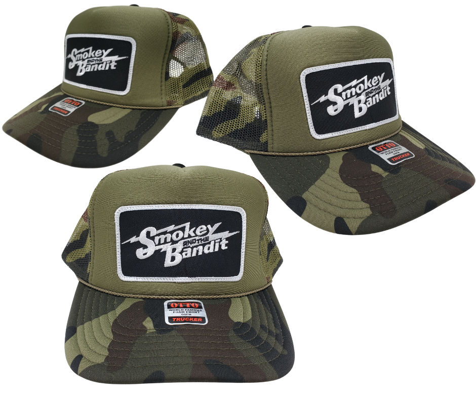 Take risks and show your adventurous spirit with our black and green camo mesh vintage foam trucker Smoky and the Bandit cap! The iconic Bandit logo meets the USA flag in this unique design. Get yours now at our Smyrna, TN store or online for the ultimate challenge and inspiration! Snap back adjustment.