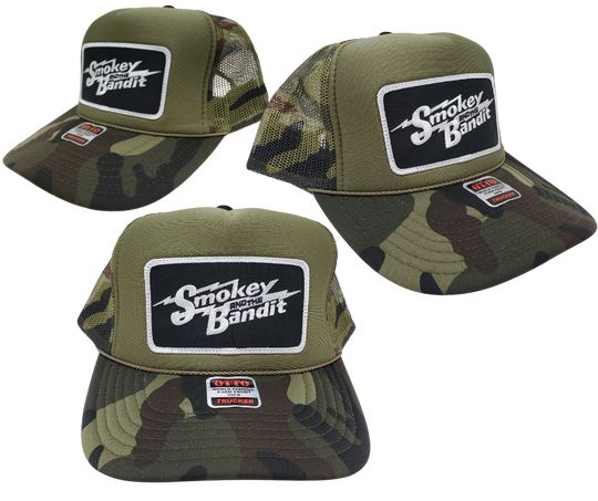 Take risks and show your adventurous spirit with our black and green camo mesh vintage foam trucker Smoky and the Bandit cap! The iconic Bandit logo meets the USA flag in this unique design. Get yours now at our Smyrna, TN store or online for the ultimate challenge and inspiration! Snap back adjustment.