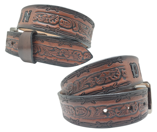 The "Bandit" Name Belt is perfect for those seeking an epic escape. It's handcrafted in Smyrna, Tennessee, just outside Nashville, and features a 1 1/2" width with a strip of vegetable tanned leather. The bold design includes an embossed Barbwire border and Western Scroll center pattern, while the changeable solid brass buckle in antique nickel finish adds a rugged touch. Make your escape in style with this hand-stained belt.