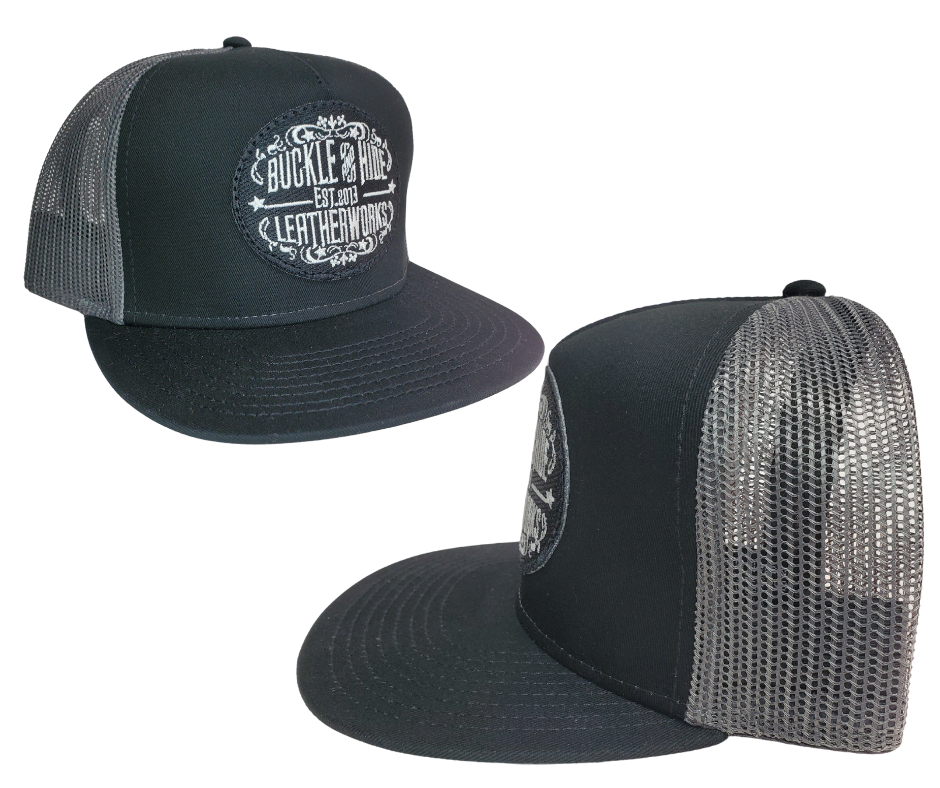 Upgrade your cap game with the Buckle and Hide Classic Flat Bill Trucker Cap, featuring a stylish mesh back, structured top and a snap back. Choose from Black, Grey, Gray/Black or Blk/Gray and proudly wear the Buckle and Hide patch on the front. From your favorite leather shop in Smyrna, TN, just outside of Nashville.