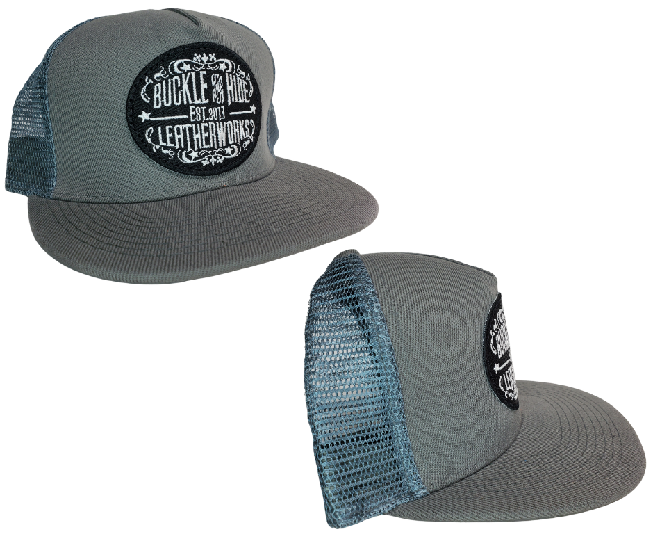 Upgrade your cap game with the Buckle and Hide Classic Flat Bill Trucker Cap, featuring a stylish mesh back, structured top and a snap back. Choose from Black, Grey, Gray/Black or Blk/Gray and proudly wear the Buckle and Hide patch on the front. From your favorite leather shop in Smyrna, TN, just outside of Nashville.