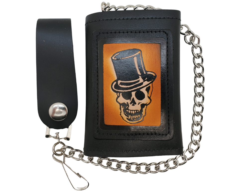 Skull Top Hat all leather Tri-fold Chain Wallet. 1 Cash Slot for all your important stash, 3 card slots and 1 underneath the middle slot. It's&nbsp;USA made&nbsp;and Buckle and Hide approved. Approx. 3"x 4" folded. 2 snap closure. Complete with an 12" chrome plated chain including leather belt loop. Available in our Smyrna, TN shop a short drive from downtown Nashville. Like most wallets&nbsp;over stuffing&nbsp;will limit the time of use. Colors may vary from picture.&nbsp;