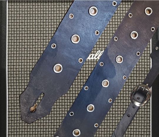 Studs and Eyelets like Marshalls have have been staple for years in Rock music!  "This 2" wide Guitar Strap is a nod to that classic influence. It's made from Pebbled Veg-Tan Cowhide and after some gig's it'll look like you bought in a Vintage shop. The classic adjustment style goes from approx. 42" to 56" at it's longest . Made just outside Nashville in our Smyrna, TN. shop. It will need a bit of time to "break in" but will get a great patina over time.  