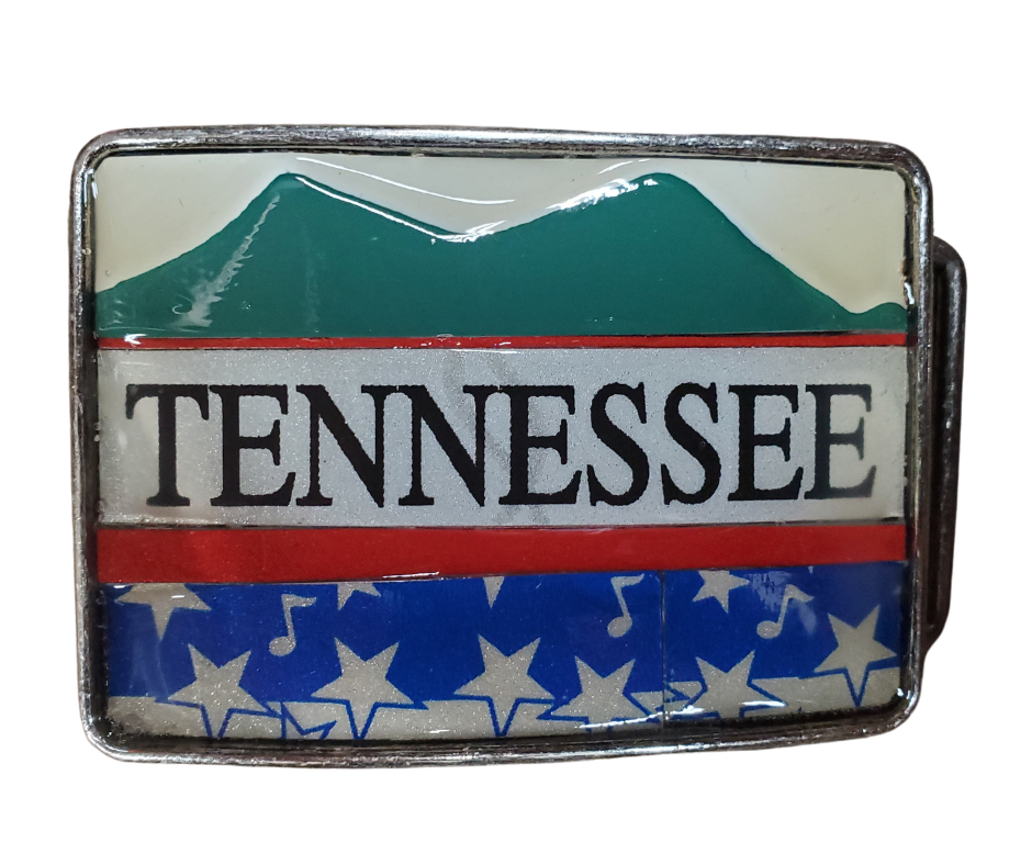 Hand Crafted Tennessee mountains look with our handmade license plate belt buckle. It's a great choice for cheering on your favorite Tennessee teams or for celebrating the great volunteer state! This eye-catching piece measures approx. 3" x 4" and can be matched with any 1 1/2" belt. Get yours today from our Smyrna, TN (near Nashville) store or online and show your style!