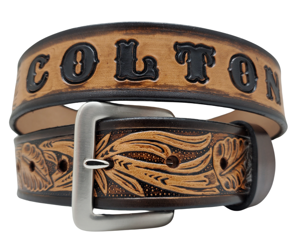 Get ready for the Rodeo adventure of The "Calgary" Name Belt! This one-of-a-kind belt features a 1 1/2" width and is hand-stained with a strip of vegetable tanned leather. The design includes a Classic Tooled Vine center pattern, while the solid brass buckle in antique nickel finish adds a touch of ruggedness. Handcrafted at our shop in Smyrna, Tennessee, just outside Nashville.