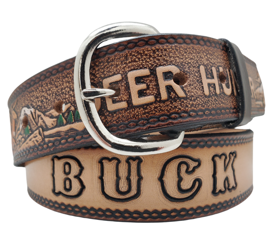 This Buck Fever all leather Name belt features a Deer Hunting pattern in an antiqued finish with a 1 1/2" width. It is crafted from full grain veg-tanned cowhide, with smooth burnished painted edges and a nickel-plated buckle.&nbsp;For customizing, simply type your desired name or No Name in the "Type Name Here" section, the buckle can be easily interchanged as well. This product is in stock at our Smyrna, TN shop.