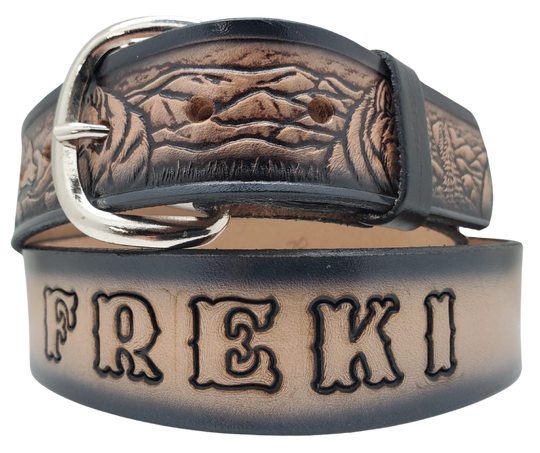 This all leather belt features a Wolf Pack pattern in an antiqued finish with a 1 1/2" width. It is crafted from full grain veg-tanned cowhide, with smooth burnished painted edges and a nickel-plated buckle. For customizing, simply type your desired name or No Name in the "Type Name Here" section, the buckle can be easily interchanged as well. This product is in stock at our Smyrna, TN shop.