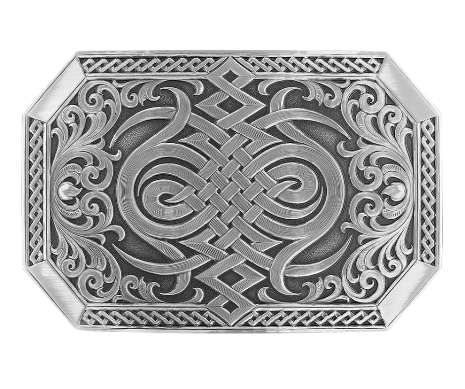 A Western inspired Celtic knot decorates the center of the buckle in a silver finish design, bookended by silver finished sideways heart's flame design with filigree scrollwork coming out from the sides. Repeating diamond pattern trim on the sides and finished 'corner' bars. The silver designs are with a deeper antiqued background. Standard 1.5in belt swivel approx. 2 1/2" x 3 3/4". Available at our Smyrna, TN just a short drive from downtown Nashville. Made by Montana Silversmith.