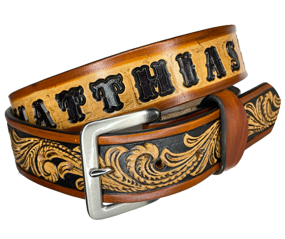 This DELUXE Rustler Name Leather Belt features a classic western Scroll pattern embossed on a 9-10 oz. vegetable-tanned cowhide. You may customize the buckle with the added snaps. It is named Deluxe because of the additional color added to the background of the pattern. This product is crafted with care in our Smyrna, TN shop, just outside Nashville, TN.