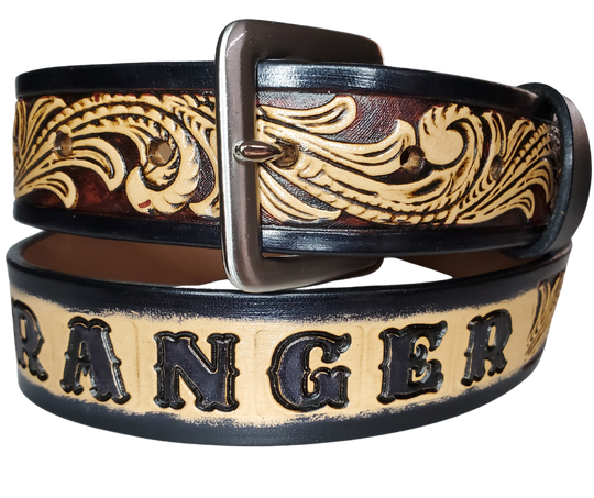 This DELUXE Rustler Name Leather Belt features a classic western Scroll pattern embossed on a 9-10 oz. vegetable-tanned cowhide. You may customize the buckle with the added snaps. It is named Deluxe because of the additional color added to the background of the pattern. This product is crafted with care in our Smyrna, TN shop, just outside Nashville, TN.