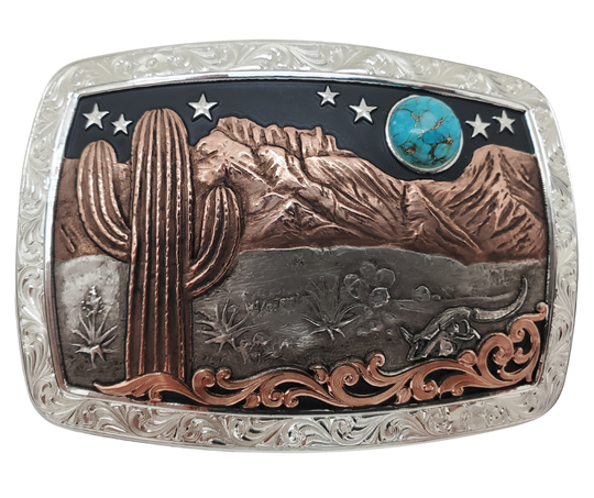 A Southwest buckle that's not so big! This 99% Silver rectangular belt buckle has Scroll work around the outer edge with a 18 karat Rose Gold Cactus, Mountains and a Turquoise Moon over the Desert scene. It's size is approx. 3" across x 2 1/2" tall and fits 3 3/4", fits up to 1 1/2" belts. Available at our Smyrna, TN just a short drive from downtown Nashville. Made by Montana Silversmith.