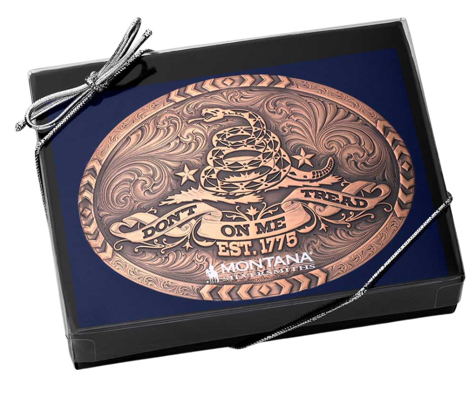 The 1776 Declaration is a Vintage Bronze Gadsden Belt Buckle. This oval buckle features a bronze tone finish. The words "Don’t Tread on Me" are featured prominently on curling ribbon at the bottom of the buckle. The Gadsden rattle snake sits ready to strike in the center of the buckle for a bold look. Chevron designs border the top, bottom, and sides giving the buckle a militant feel. Approx 4"x3" Standard 1.5 inch belt swivel. Get yours at our local Smyrna, TN not far from Nashville.