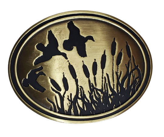 Experience the classic game, Duck Hunt, with The Duck Hunt Belt Buckle. Finished in antique brass makes a great match for our mallard belt.  Designed to fit a 1 1/2" belt and the size approx. 3-1/2" x 2-3/4. . available in our Smyrna, TN shop near Nashville, this dynamic and detailed buckle is perfect for the Duck Hunter.