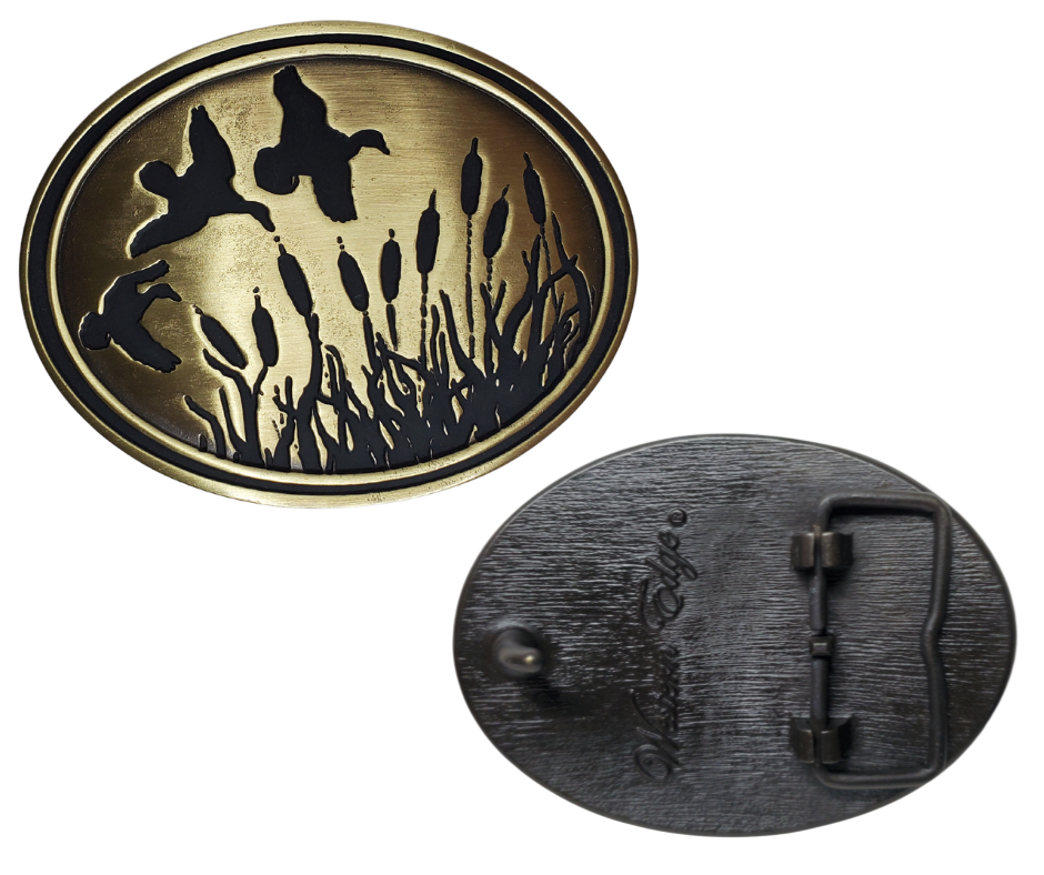 Experience the classic game, Duck Hunt, with The Duck Hunt Belt Buckle. Finished in antique brass makes a great match for our mallard belt.  Designed to fit a 1 1/2" belt and the size approx. 3-1/2" x 2-3/4. . available in our Smyrna, TN shop near Nashville, this dynamic and detailed buckle is perfect for the Duck Hunter.