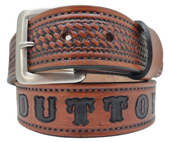 New to our line "The Dutton" Name Leather Belt - a personalized accessory made in Smyrna, TN. This timeless piece features a classic basket weave embossed stitch border and an interchangeable solid brass buckle for convenience and quality. Elevate any outfit with ease.