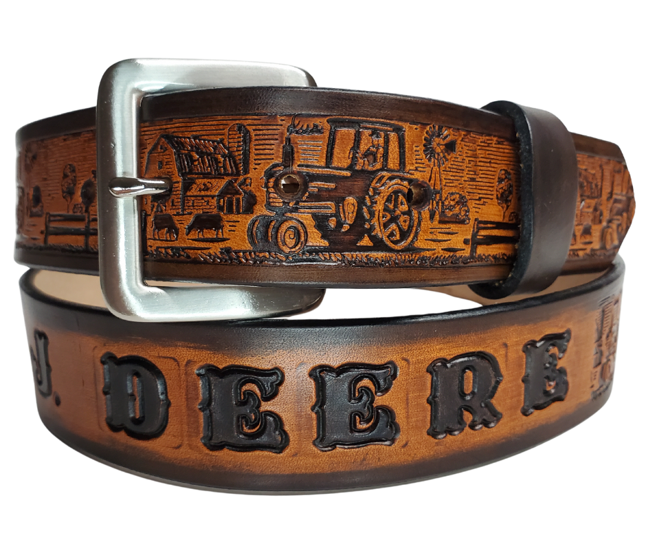 The Homestead Belt showcases the quintessential self-sustaining lifestyle through the imagery of Chickens, Tractors, Cows, and Barns. Made with 1/8" thick leather and 1 1/2" wide, the Antiqued Solid Buckle Silver is easily interchanged with two snaps. Personalize your belt with up to 10 letters. Buy yours online or come see us in Smyrna, TN, close to Nashville.