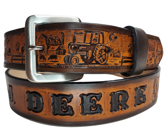 The Homestead Belt showcases the quintessential self-sustaining lifestyle through the imagery of Chickens, Tractors, Cows, and Barns. Made with 1/8" thick leather and 1 1/2" wide, the Antiqued Solid Buckle Silver is easily interchanged with two snaps. Personalize your belt with up to 10 letters. Buy yours online or come see us in Smyrna, TN, close to Nashville.