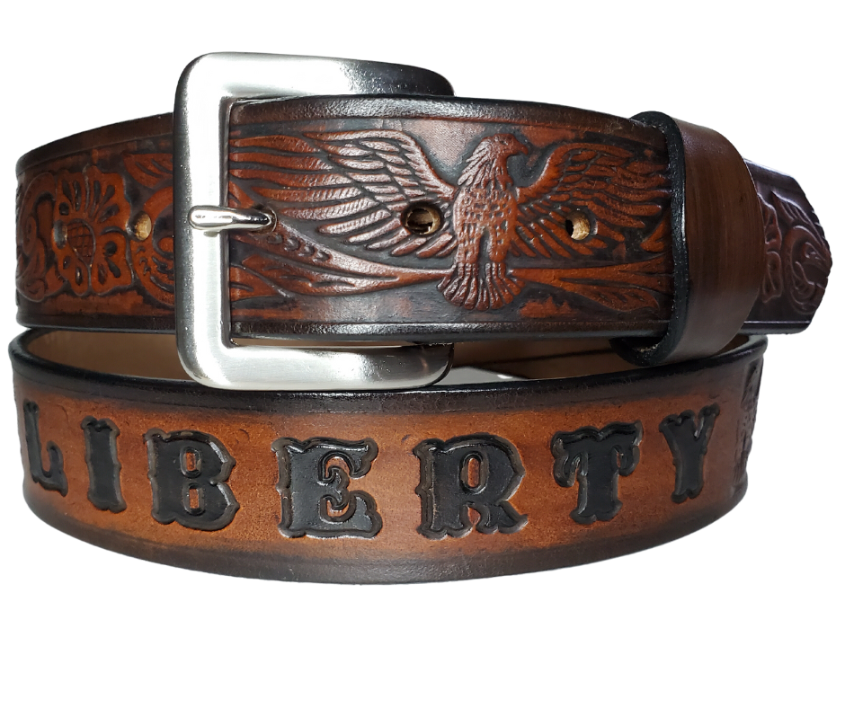 This Name Belt features a single strip of vegetable tanned leather in a patriotic pattern, highlighted by a flying eagle. The antique nickel-finished solid brass buckle is easily replaceable, allowing you to customize the design with your own buckle. It's crafted in our Smyrna, Tennessee shop, near Nashville.