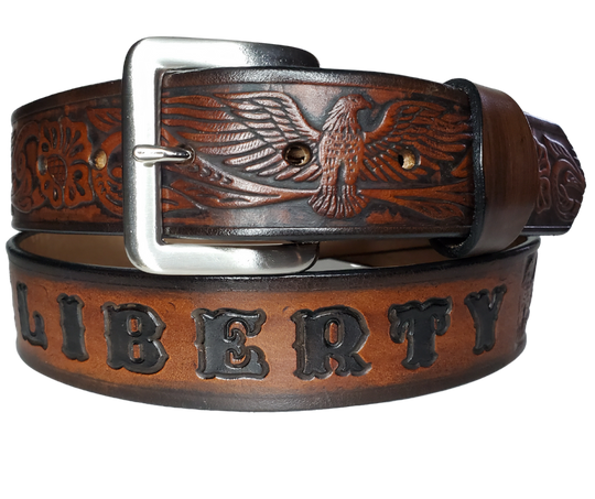 This Name Belt features a single strip of vegetable tanned leather in a patriotic pattern, highlighted by a flying eagle. The antique nickel-finished solid brass buckle is easily replaceable, allowing you to customize the design with your own buckle. It's crafted in our Smyrna, Tennessee shop, near Nashville.