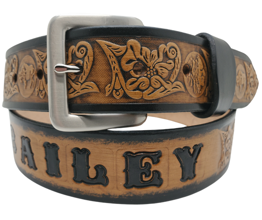 This unique Name Belt features a hand-stained strip of vegetable tanned leather, displaying a Western Scroll design and both sides of the iconic Buffalo Nickel pattern. The antique nickel finish solid brass buckle can be easily changed. Handcrafted in our Smyrna, Tennessee shop, near Nashville.