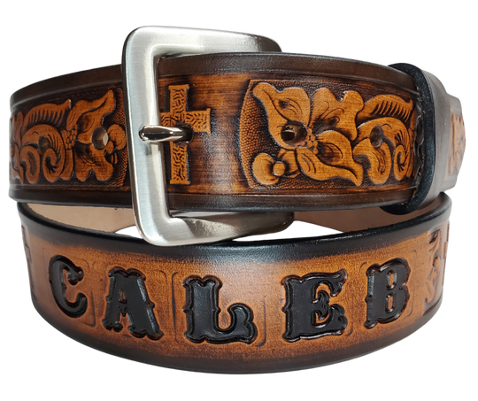 Named after the well known Bible verse...Choose this day whom you will serve! Experience a western-inspired flair with the "Joshua 24:15" Name Leather Belt. Featuring a striking floral pattern and Cross running along its length, you can even customize the name with up to 10 letters. Crafted from 1/8" thick leather and 1 1/2" wide, its Antiqued Solid Buckle Silver is attached with two snaps for an easy change. Take the next step and order yours online or visit our shop in Smyrna, TN, near Nashville.