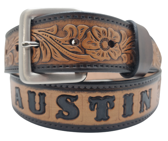 Unleash your western inner self with The "Lariat" Name Belt. Each belt features a unique hand-stained strip of vegetable tanned leather, adorned with a bold and timeless Western Floral pattern. The antique nickel finish solid brass buckle can be effortlessly swapped out. Crafted by hand at our Smyrna, Tennessee shop, just a stone's throw away from Nashville.