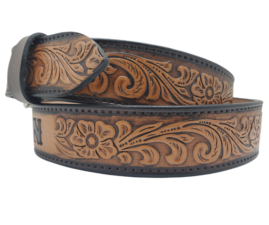 Unleash your western inner self with The "Lariat" Name Belt. Each belt features a unique hand-stained strip of vegetable tanned leather, adorned with a bold and timeless Western Floral pattern. The antique nickel finish solid brass buckle can be effortlessly swapped out. Crafted by hand at our Smyrna, Tennessee shop, just a stone's throw away from Nashville.