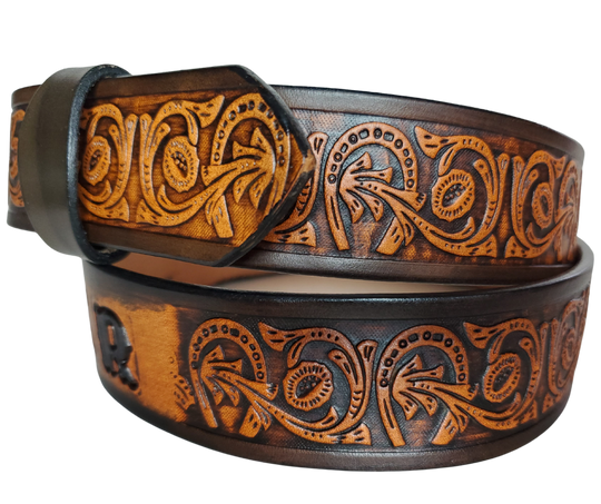 We are always trying to find classic iconic patterns and this is one of those....Horseshoes mixed with a Western scroll pattern. It's a professionally crafted, genuine leather belt made from 8-10 oz cowhide shoulder leather, approximately 1/8" thick. It boasts a hand burnished edge, along with a multi-step dye and finishing technique. The antique nickel plated solid brass buckle is affixed with heavy snaps. This belt is crafted near Nashville, TN in Smyrna.