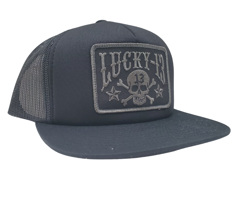 The Lucky 13 Skull and Stars snapback trucker cap has the "Skull and Stars" graphic on front and a "Lighting Bolt 13" embroidered on the back left side. Front is Twill, back is Mesh. There is an adjustable snap back to assist in helping this hat fit almost any size head. Come and and get'em at our Smyrna, TN shop a short ride outside Nashville.

COLOR: BLACK/GREY EMBROIDERY