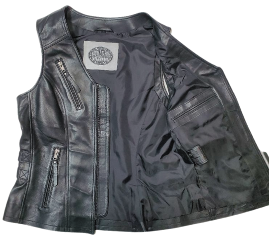 This super soft Lambskin ladies' vest features zippered pockets, V-neck design, and buckle detailing on the sides for a comfortable look. The 3 panel back, lower back zippered gussets, and zipperd front closure add to the practicality of this vest.&nbsp; Visit our leather shop in Smyrna, TN, near Nashville, and choose from sizes small to 5x.  Includes inside Carry conceal pockets, 3 zippered outside pockets  3 panel back with lower gussets for extra comfort