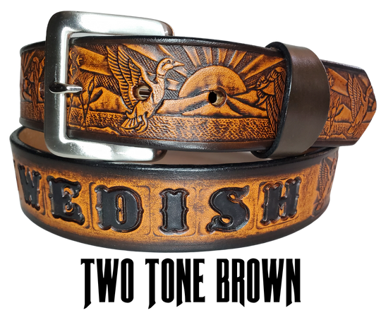 This solid strip of Veg Tan cowhide, is hand stained in 4 brown options, with smooth, finished edges. Embossed with a Mallard Duck scene down length of belt, or have name added to scene up to 8 letters. Belt thickness is approx. 1/8", and 1 1/2" wide. Sizes available are 34" to 44" from buckle end to hole most worn. Attached with 2 snaps is a Brushed Nickel plated solid brass buckle. 