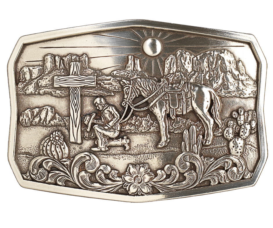 This handsome, one-of-a-kind buckle displays an antiqued silver finish, an old wooden cross, and a cowboy in prayer to our Lord, all against a hot desert backdrop. At approx. 2 1/2" tall and 3 1/2" wide, it fits belts up to 1 1/2" wide and is available for purchase from our physical store in Smyrna, Tennessee as well as our online store. Imported.