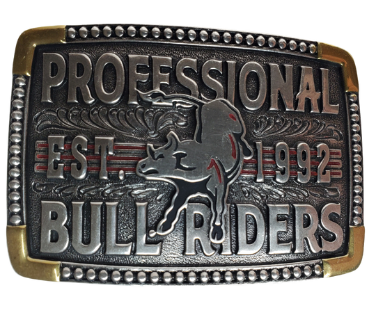 The cast Attitude buckle with PBR colors to make the buckle vibrant and stand out. "Professional Bull Riders" Est. 1992 and Bull in the center with a beaded edge completes the rectangle shape. Fits 1 1/2" belts and is approx. 3" tall x 4"across. Available at our shop just outside Nashville in Smyrna, TN. Made by Montana Silversmith.