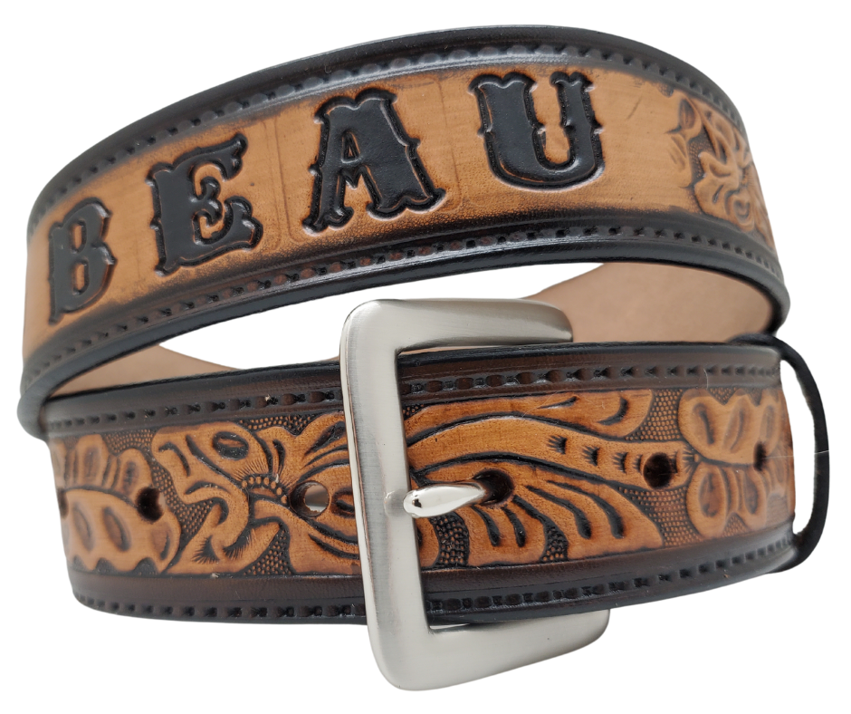 Get ready for an unforgettable Rodeo adventure with The "Pendleton" Name Belt! This one-of-a-kind belt features a 1 1/2" width and is hand-stained with a strip of vegetable tanned leather. The bold design includes a embossed stitch border and Classic Tooled center pattern, while the solid brass buckle in antique nickel finish adds a touch of ruggedness. Handcrafted at our shop in Smyrna, Tennessee, just outside Nashville.