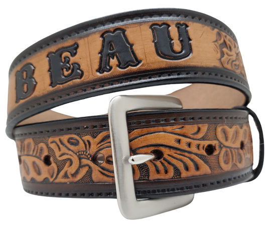 Get ready for an unforgettable Rodeo adventure with The "Pendleton" Name Belt! This one-of-a-kind belt features a 1 1/2" width and is hand-stained with a strip of vegetable tanned leather. The bold design includes a embossed stitch border and Classic Tooled center pattern, while the solid brass buckle in antique nickel finish adds a touch of ruggedness. Handcrafted at our shop in Smyrna, Tennessee, just outside Nashville.