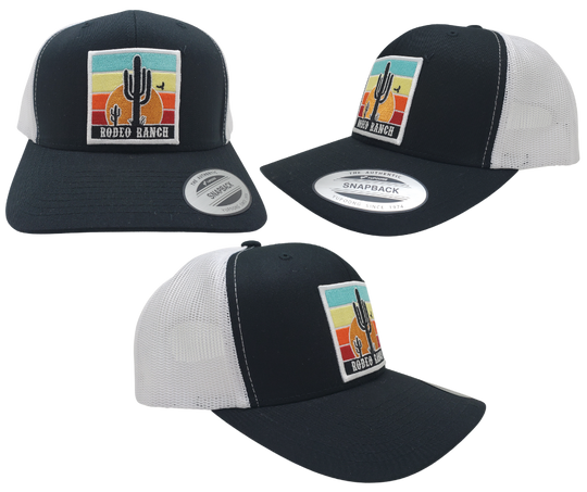 Embrace the thrill of the Rodeo. This Embroidered Trucker Cap features a vibrant desert sun and a towering Cactus. With a Black front, White mesh trucker style, and a snapped adjustable strap, it's ready for any adventure. Visit our Smyrna, TN shop just outside Nashville and claim yours today!