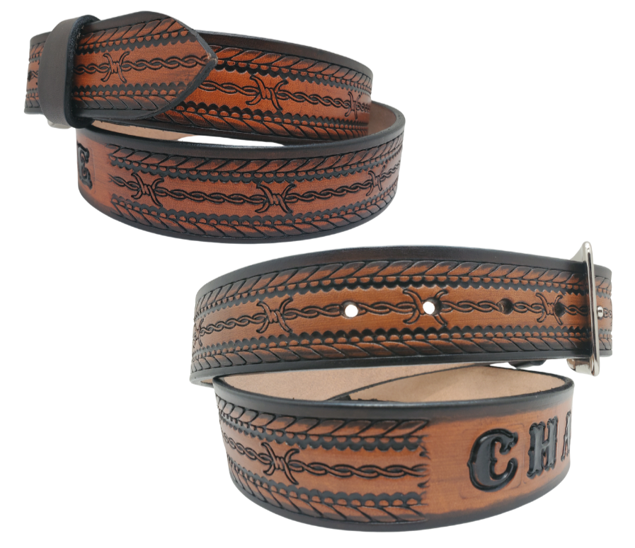 Get ready for an unforgettable adventure with The "Stampede" Name Belt! This one-of-a-kind belt features a 1 1/2" width and is hand-stained with a strip of vegetable tanned leather. The bold design includes a Rope border and Barbwire center pattern, while the solid brass buckle in antique nickel finish adds a touch of ruggedness. Handcrafted at our shop in Smyrna, Tennessee, just outside Nashville.