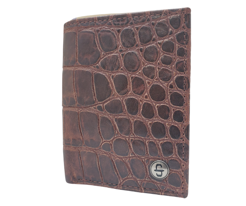 Fully Licensed Stetson Logo Trifold Wallet. Made from Cognac Brown Croc or Black print cowhide leather so good it's really hard to tell the difference from the real thing! Classic Trifold design on the inside made from soft durable cowhide leather. Featuring 6 card slots along 2 underside pockets, large cash slot and I.D. pocket in the center. In stock at our Smyrna, TN retail store 30 min. from downtown Nashville. Imported.