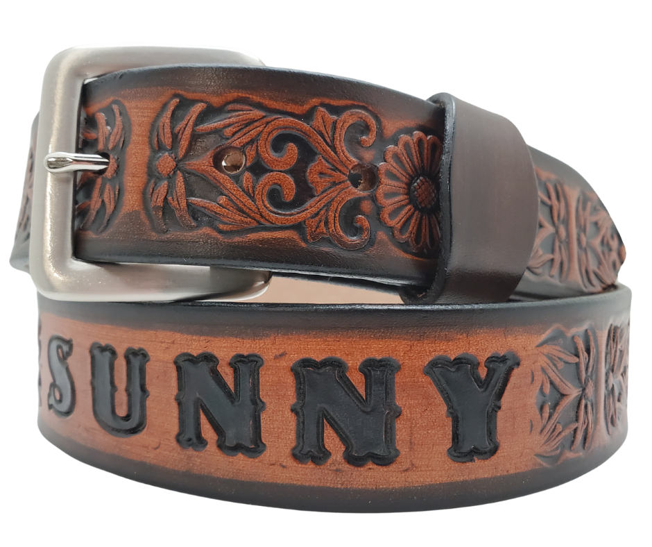 "The Sun Daisy" is a handmade real VEGTAN belt made from a single strip of cowhide shoulder leather that is 8-10 oz. or approx. 1/8" thick. It has hand burnished (smoothed)&nbsp;edges and Summer flowers embossed on the surface.&nbsp;The antique nickel plated solid brass buckle is snapped in place with heavy snaps.&nbsp; This belt is made just outside Nashville in Smyrna, TN.