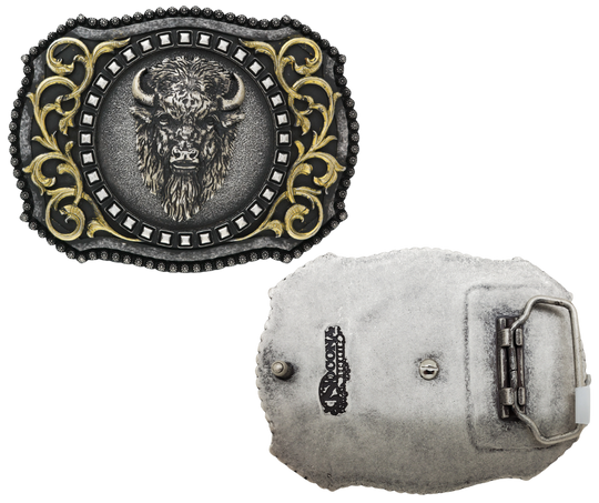 The Buffalo, a beloved Western symbol, now has a stylish and approachable accessory to complete your look. This rectangular belt buckle features a Brass-colored western scroll design with a Tantanka head in the center, surrounded by rounded bead edges. Measuring 3" tall by 4" wide, it's perfectly sized to fit belts up to 1 1/2" wide. You can find it at our retail shop in Smyrna, TN, located just outside of Nashville, or online.