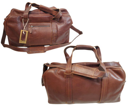 The Traveler Leather Duffel bag is available at our Smyrna, TN shop not far from Nashville. It has a single zip pocket on the side approx. 6.5 x 6.5”. Detachable leather shoulder strap is reinforced with cotton webbing, 2 leather strap handles, one on each side with reinforcement stitching and handle snaps. Spacious inside compartment with a two-way zipper. Inside pockets on each side one zips and the other is open. Lined with sturdy fabric. Bottom of bag has five rounded feet 