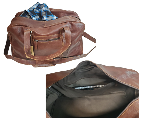 The Traveler Leather Duffel bag is available at our Smyrna, TN shop not far from Nashville. It has a single zip pocket on the side approx. 6.5 x 6.5”. Detachable leather shoulder strap is reinforced with cotton webbing, 2 leather strap handles, one on each side with reinforcement stitching and handle snaps. Spacious inside compartment with a two-way zipper. Inside pockets on each side one zips and the other is open. Lined with sturdy fabric. Bottom of bag has five rounded feet 